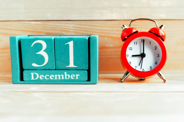 December 31. Blue cube calendar with month and date on wooden background. December 31. Blue cube calendar with month and date on wooden background. number 31 stock pictures, royalty-free photos & images