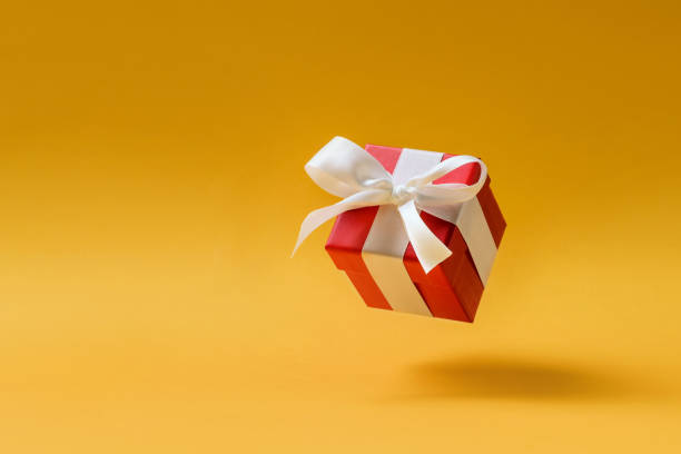 istock Red jewelry box levitating on a yellow background 1284416795