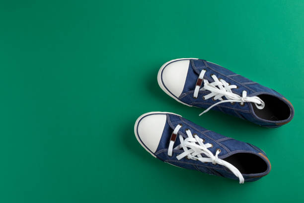 istock New blue gumshoes on green background 1284417638