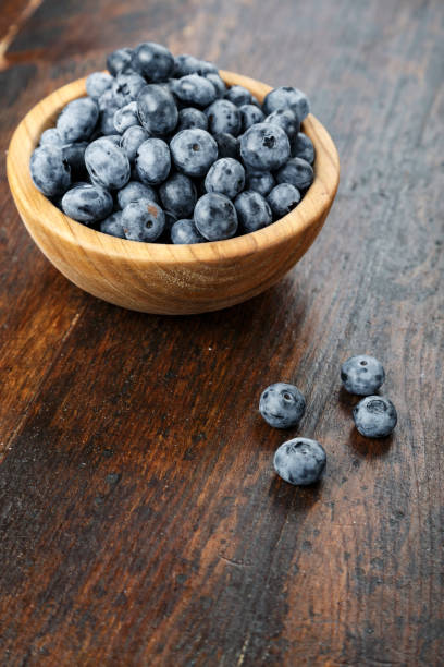 istock Fresh blueberries in a wooden bowl 1284417700