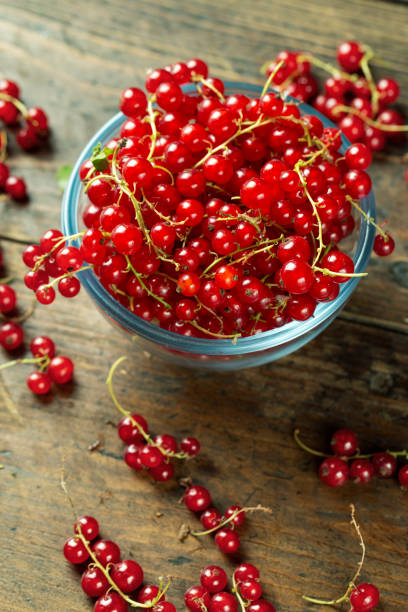 istock Sweet fresh red currant in a plate on wood table. 1284417754