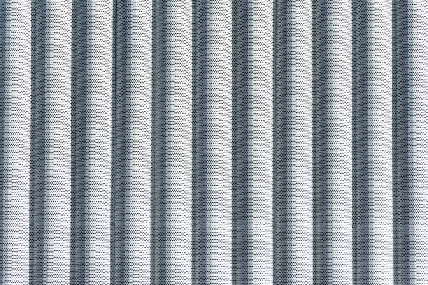 istock Background of white metal columns with evenly placed holes 1284419420
