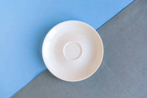 istock Empty plate on grey and blue background. Copy space for the text. Minimal concept 1284419452
