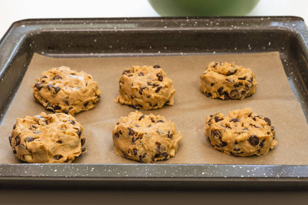 istock Chocolate chip cookies close up on a parchment-lined baking sheet 1284419952