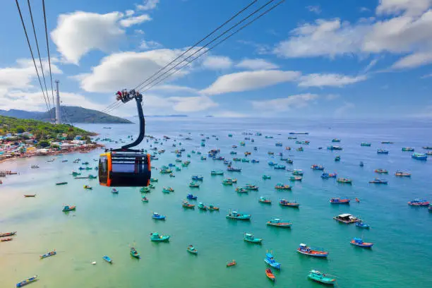 Photo of Hanging cabin on the Phu Quoc cable car to Hon Thom Island above azure sea.