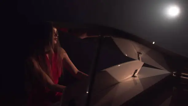 Photo of 4K Footage Of Female Pianist Plays In Beautiful Grand Piano On Stage In Concert . A woman plays the piano in the concert hall. Stage light and light fog on the background
