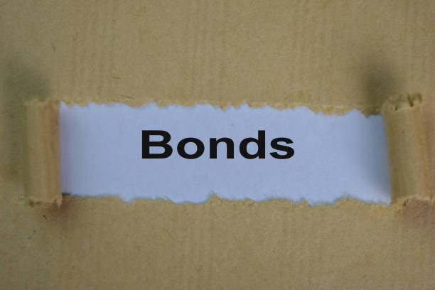 istock Close up Bonds Text written in torn paper. 1284422350