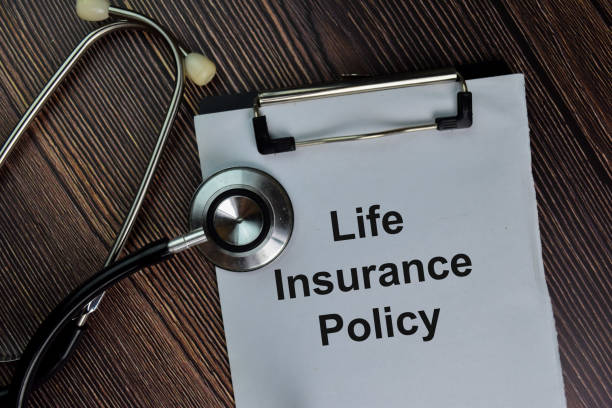 istock Life Insurance Policy write on a paperwork isolated on wooden table. 1284422862