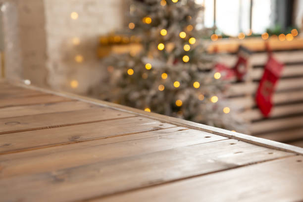background and backdrop. wooden shelf against background of new year glowing garland on christmas tree - christmas table imagens e fotografias de stock