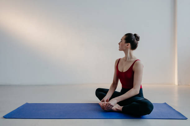 istock Young beautiful yoga woman is posing in studio. 1284423020
