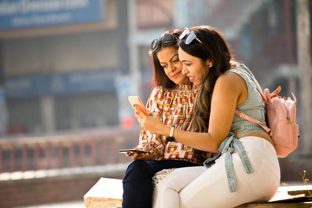 istock Women enjoying funny video on mobile phone 1284423039