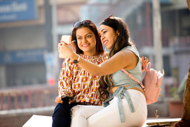 istock Women enjoying funny video on mobile phone 1284423099