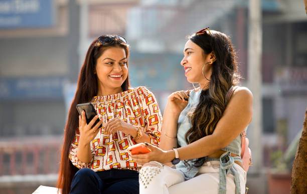 istock Women enjoying funny video on mobile phone 1284423201
