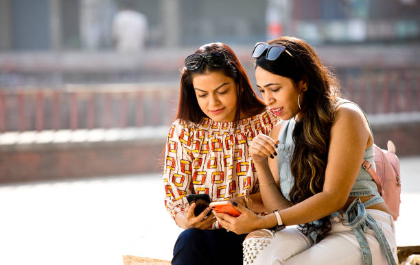 istock Women enjoying funny video on mobile phone 1284423244