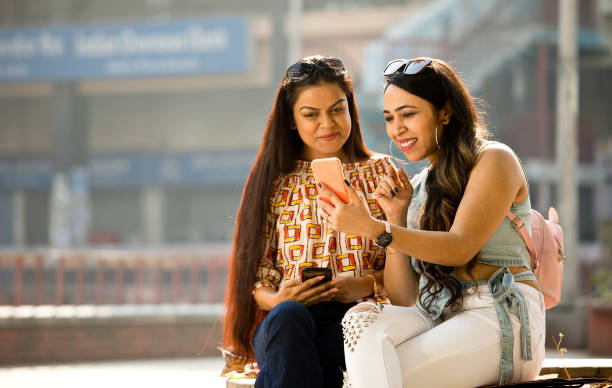 istock Women enjoying funny video on mobile phone 1284423344