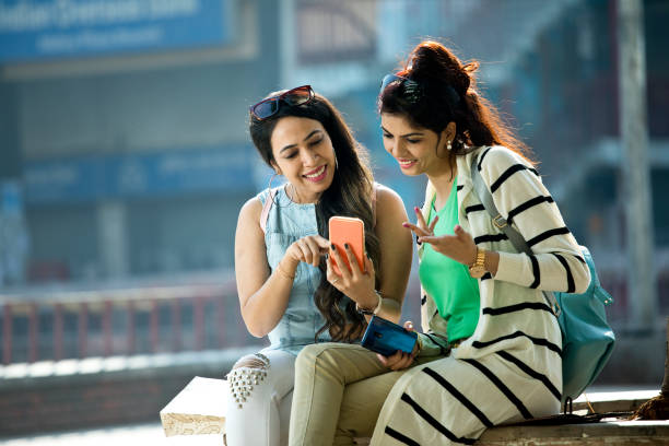 istock Women enjoying funny video on mobile phone 1284423405