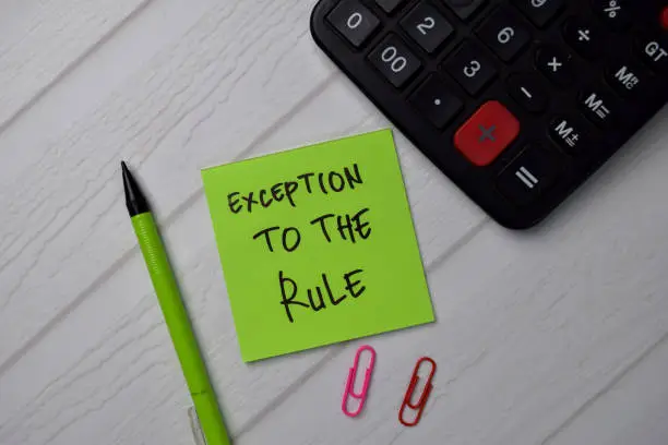 Exception to the Rule write on sticky notes isolated on office desk.