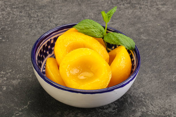 istock Sweet ripe canned peaches with mint 1284423599