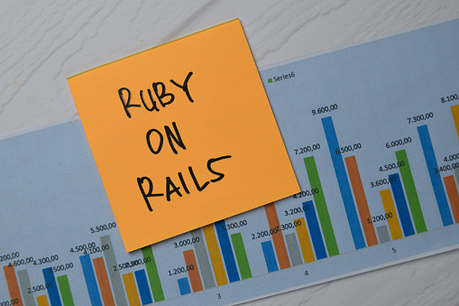 Ruby On Rails write on sticky notes with graphic on the paper isolated on office desk.