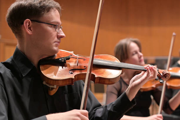 istock musicians in black clothes play violins rehearsing a performance 1284425028
