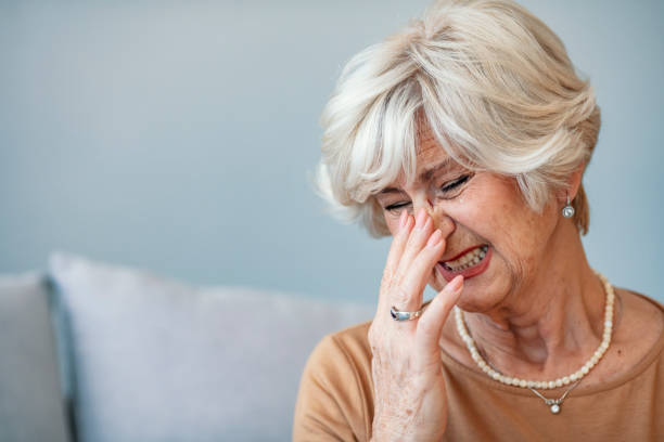 istock Elderly woman suffering from headache at home. 1284425072