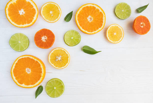 istock Lemons, lime, orange and grapefruit cut in circles on a white background with space for text. Poster, banner, article. 1284425078