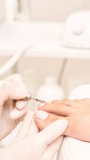istock Classic pink wedding toe nail manicure on white backdrop. Spa treatment concept 1284426567