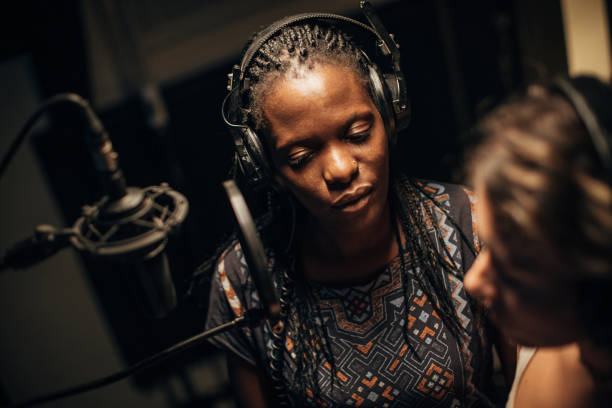 istock Two female singers singing a duet in recording studio together 1284427638