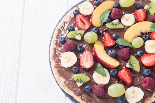 istock Fruit pizza with nut nougat cream , fruit and berries 1284428778