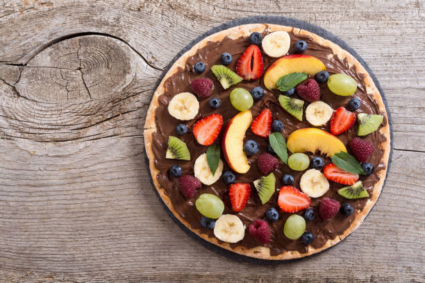 istock Fruit pizza with nut nougat cream , fruit and berries 1284428792