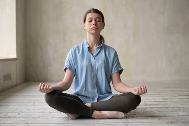 istock Young woman meditates in an empty apartment. Searching for harmony 1284429984