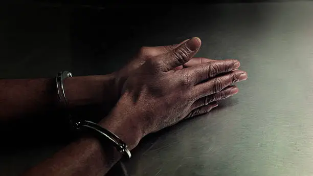 Photo of Handcuffed hands of an African American man