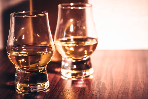 istock Selective focus glasses of whiskey on rustic wood background 1284431144