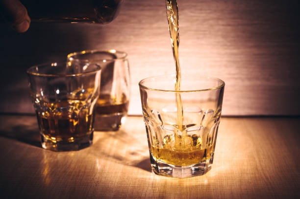 istock Selective focus glasses of whiskey on rustic wood background 1284431158