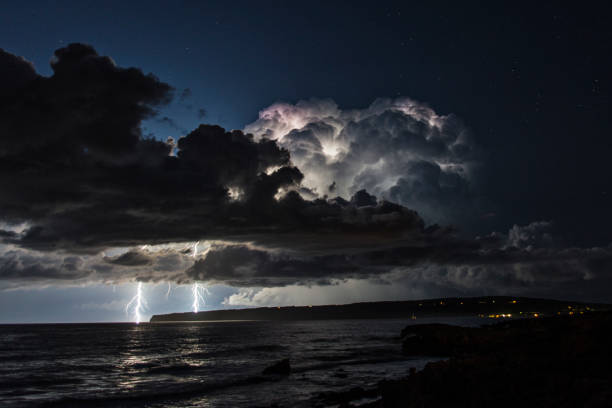 istock electrical storm over the mediterranean sea with two lightning strikes falling into the water 1284433677