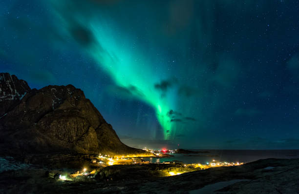 istock aurora borealis over a village next to a great mountain 1284433679