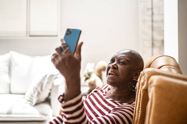 istock Senior woman doing a video call on smartphone at home 1284433979