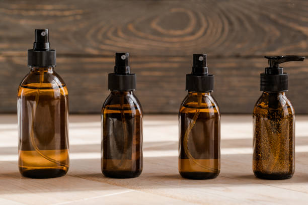 istock Cosmetic dark amber bottles on wooden  table 1284435625