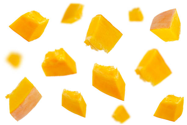 istock Falling pumpkin slices isolated on a white background, selective focus. Set of pumpkin slices in the air. Pumpkin slices fall. Pumpkin slices in the air on a white background. 1284435951