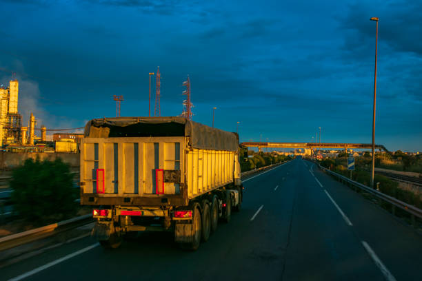 istock Tipper truck driving on a highway 1284436736