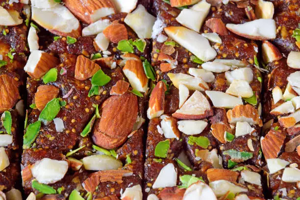 Traditional Indian sweet Anjeer or Anjir (Dry Fig) barfi richly garnished with almaonds, pistachios and cashewnuts to be gifted or exchanged on special occasions.