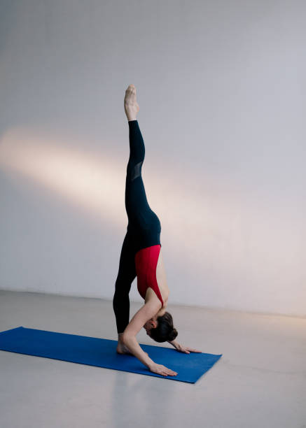 istock Young beautiful yoga woman is posing in studio. 1284438845