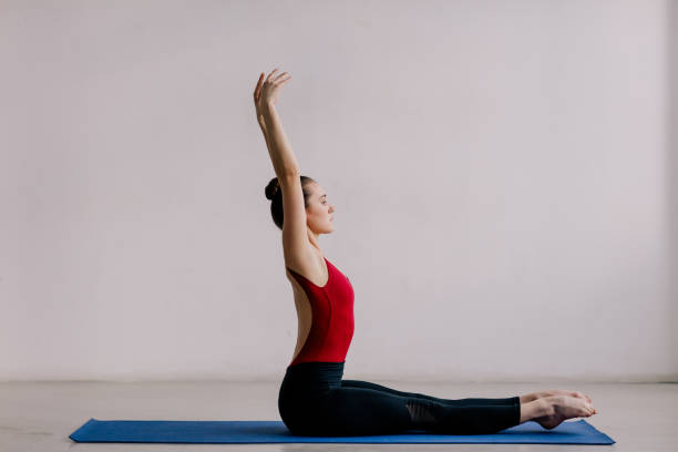 istock Young beautiful yoga woman is posing in studio. 1284438970