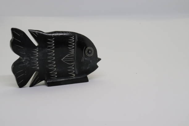 istock fish figure carved from black memer 1284439383