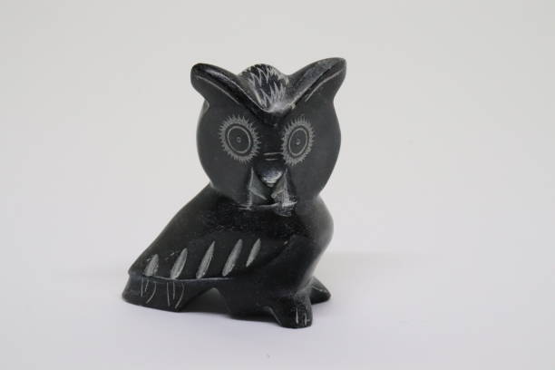 istock owl figure carved from black memer 1284439517