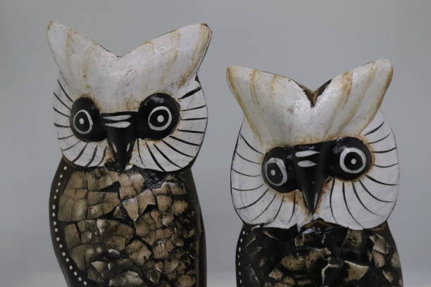 istock two wooden owl figures on white background 1284439632