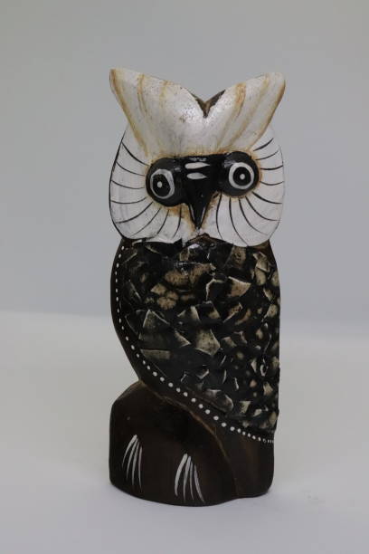 istock a wooden owl figures on white background 1284439673