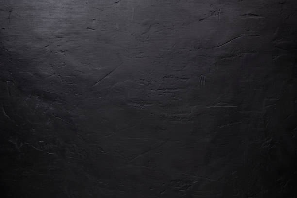 istock Top view of black stone pattern, background with scratches and dents with copy space for text or any design 1284440657
