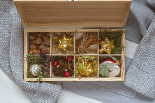 istock Christmas decorations box with various herbs on soft sweater background. Cozy Christmas time, winter holiday season. 1284441886