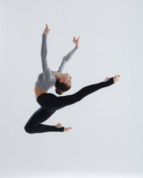 istock Young gymnast girl stretching and training 1284443362